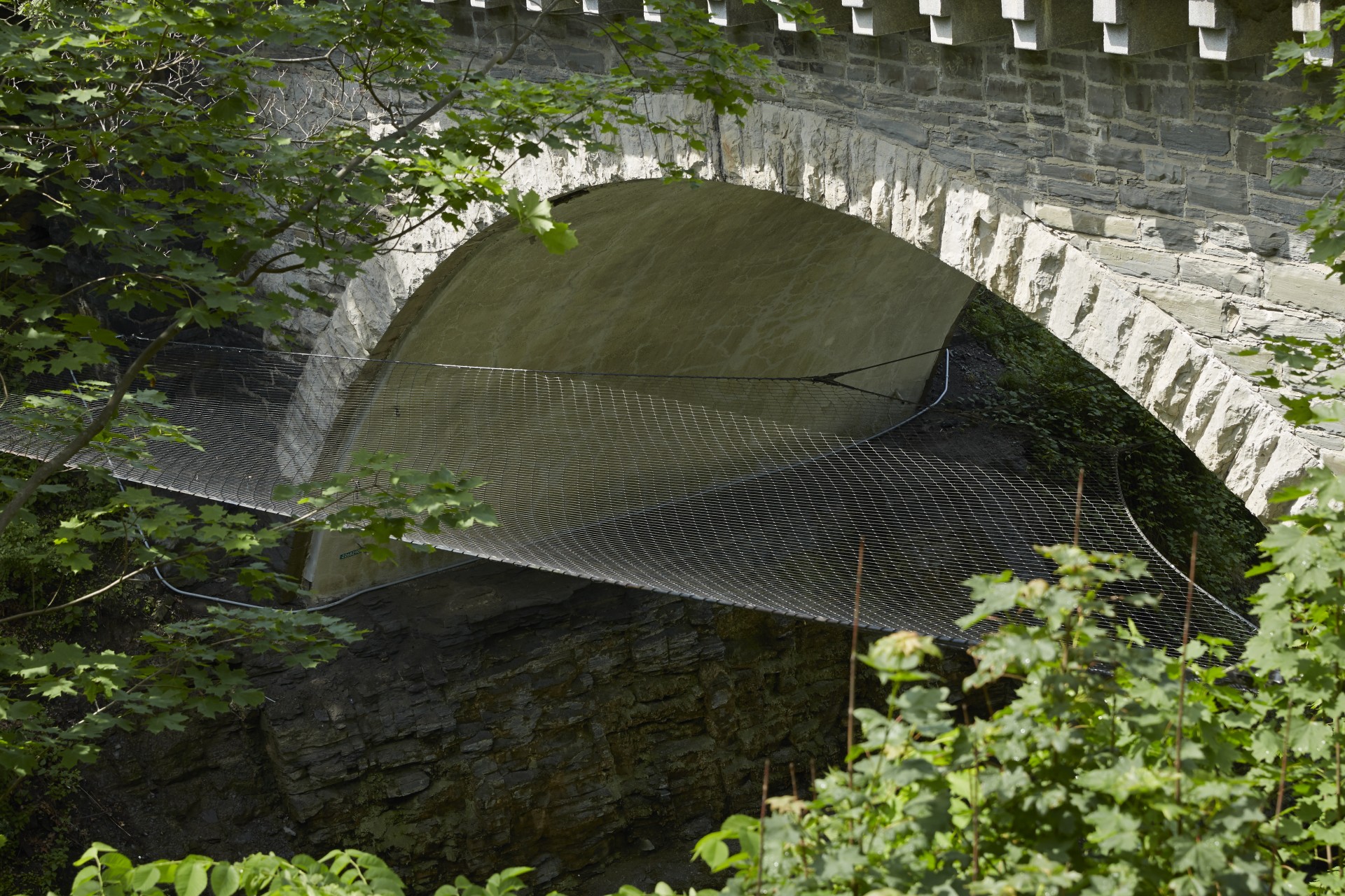historic bridge over river with safety net